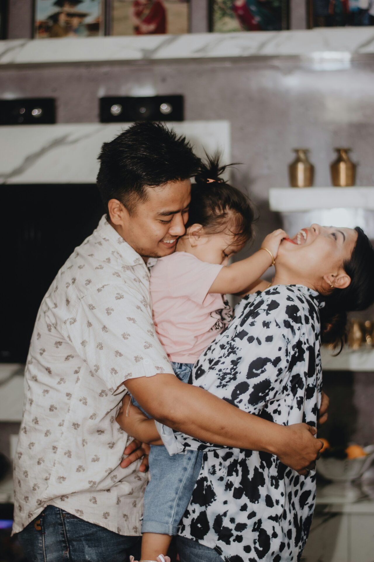 A family laughs as they hug each other.