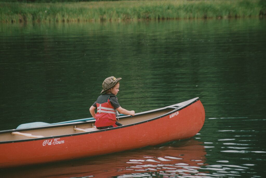 A child paddles in a canoe