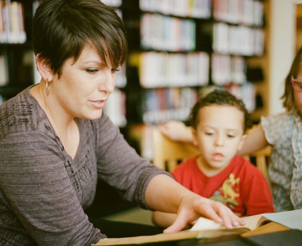 A woman tutors a young student.
