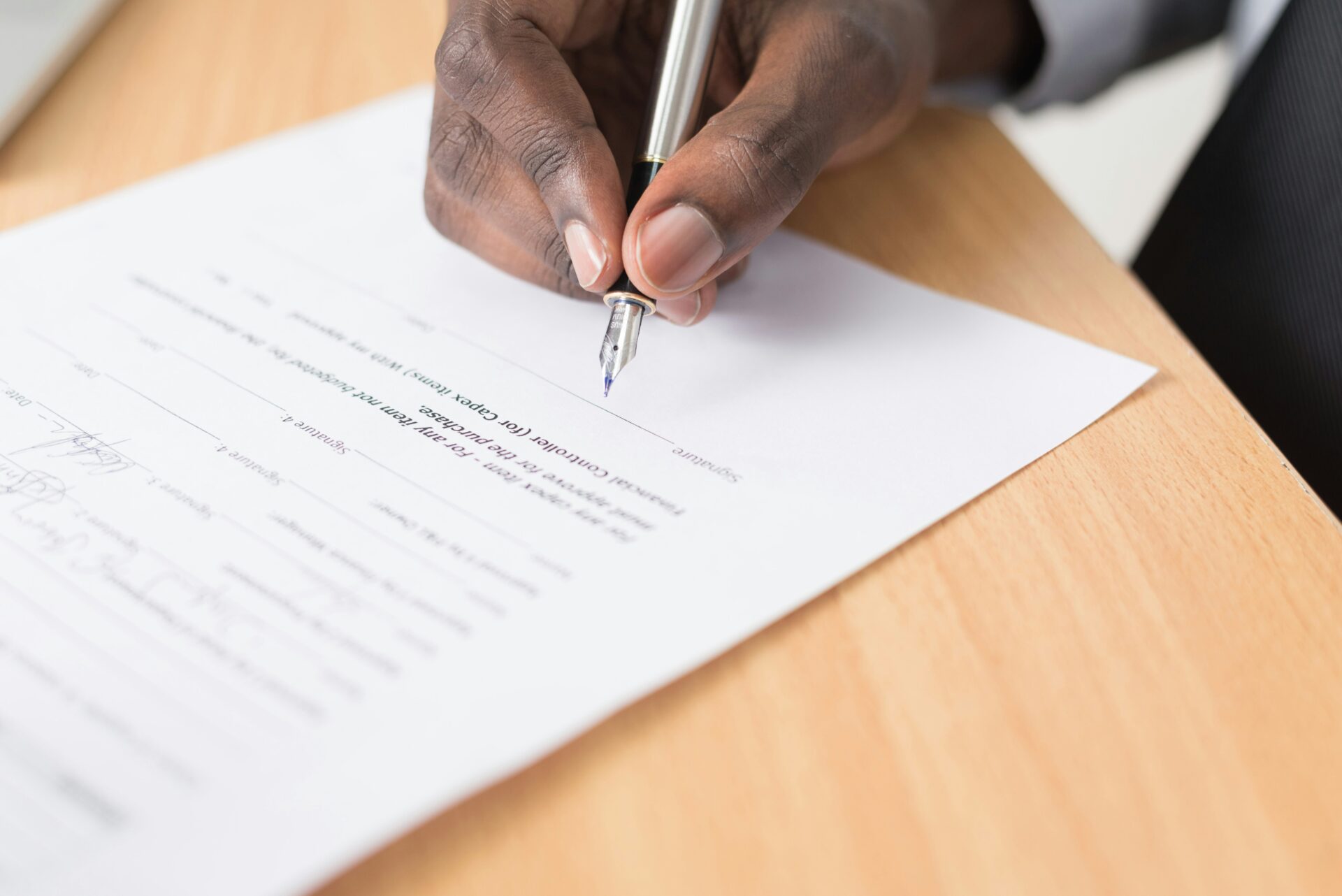 Person signs a report card.