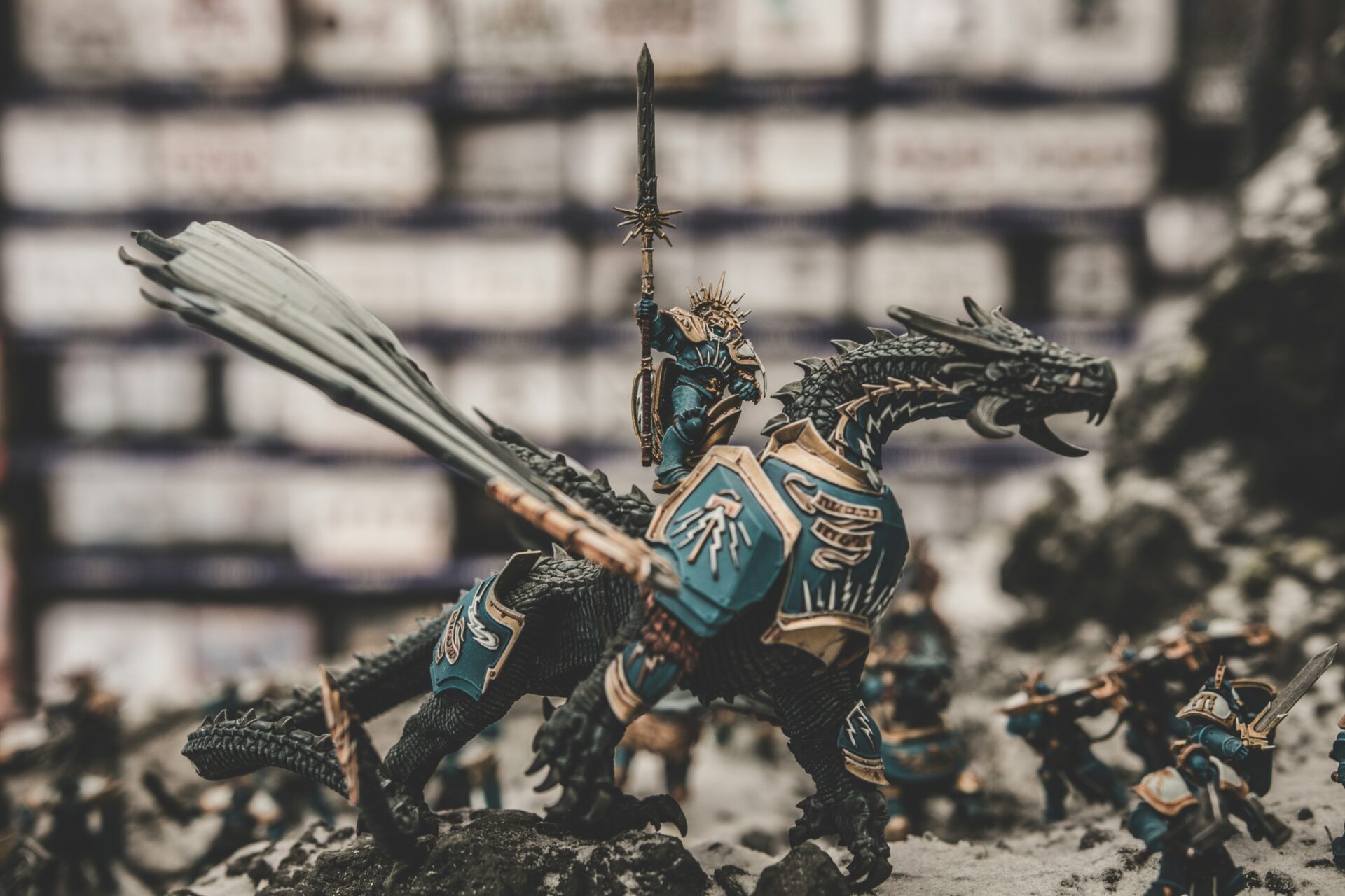 A Dungeons and Dragons knight sits atop a dragon game piece on a table.