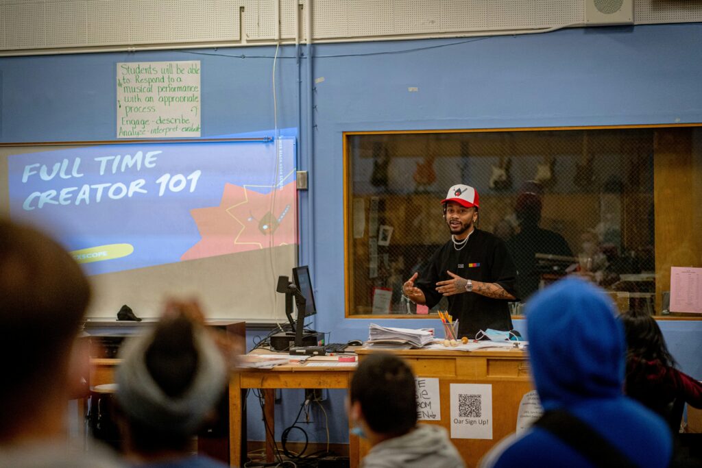 A teacher instructs a classroom of students.
