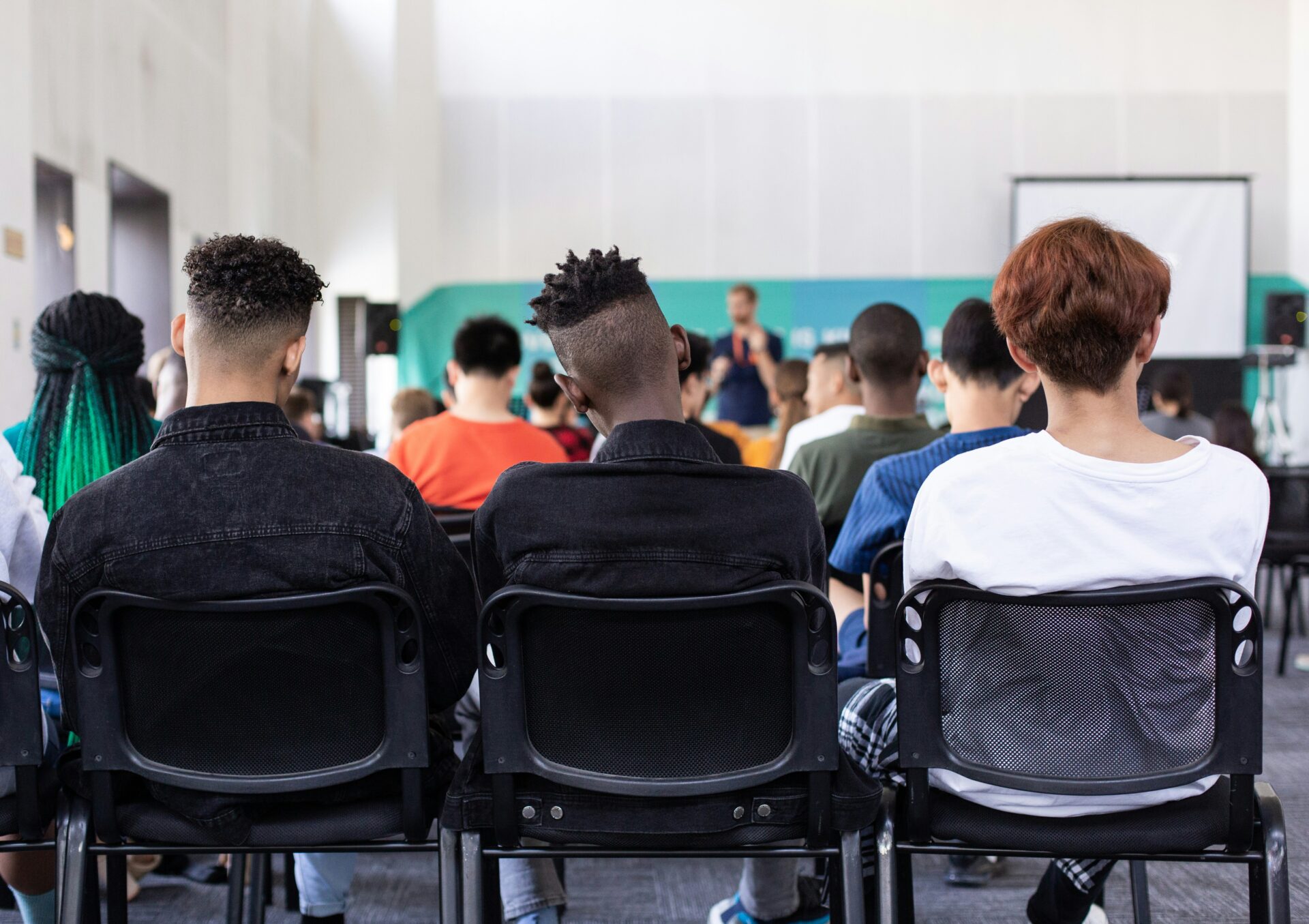 High school students sit in a school assembly.